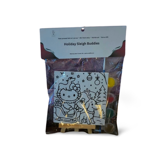 Holiday Sleigh Buddies mini canvas paint kit packaged in a clear bag with topper, featuring kitty in a sleigh with reindeer, paint pots, and brush on a small easel.